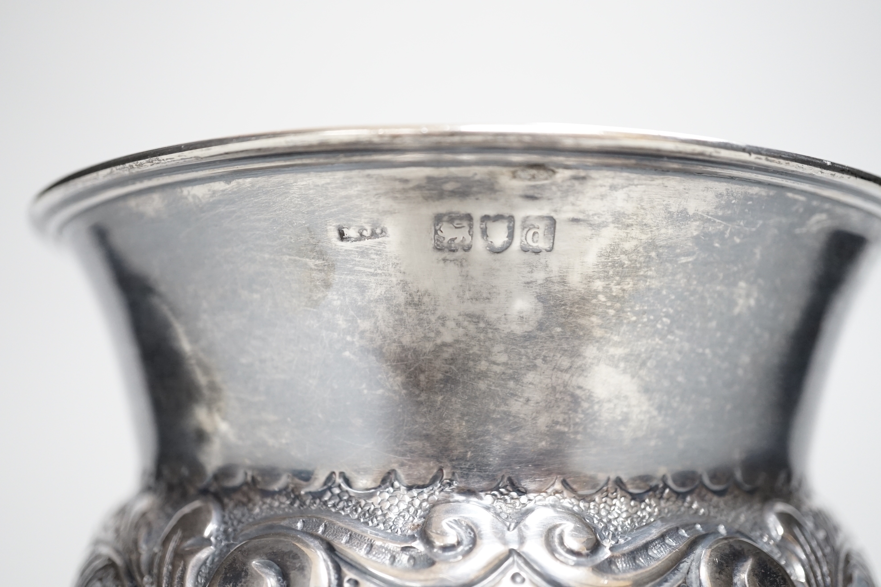 A late Victorian embossed silver bulbous pedestal vase, Matthew John Jessop, London, 1899, height 10.7cm, 6.7oz.